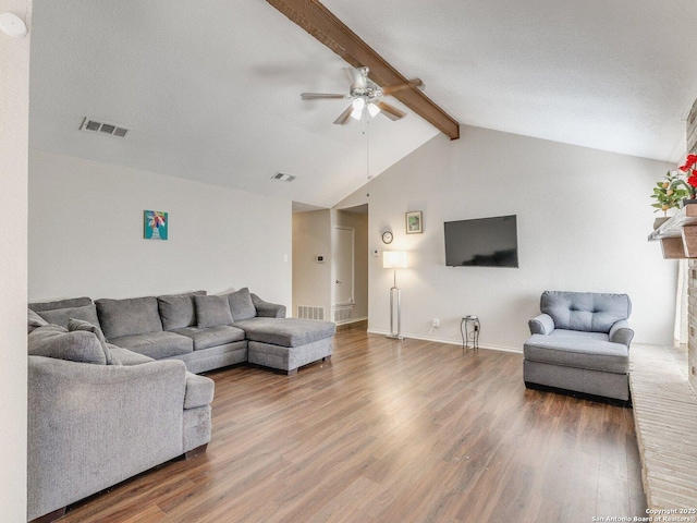 living room featuring wood-type flooring, vaulted ceiling with beams, and ceiling fan