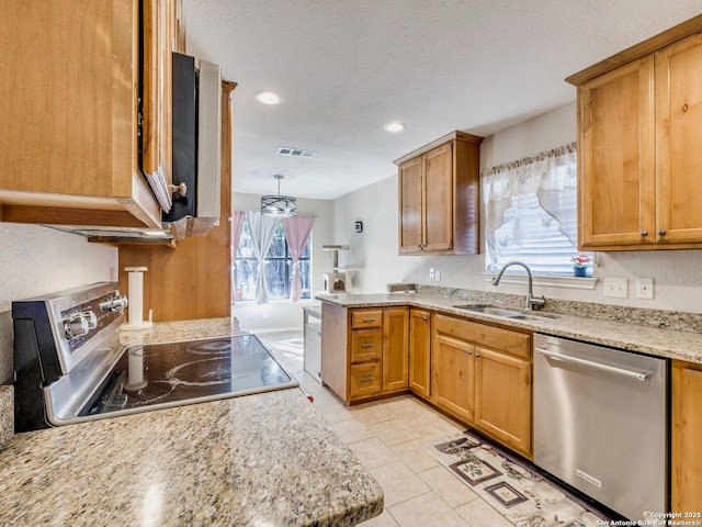 kitchen with sink, light stone counters, light tile patterned floors, pendant lighting, and stainless steel appliances