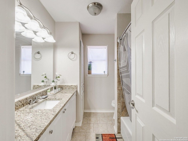 bathroom featuring tile patterned flooring, vanity, and toilet