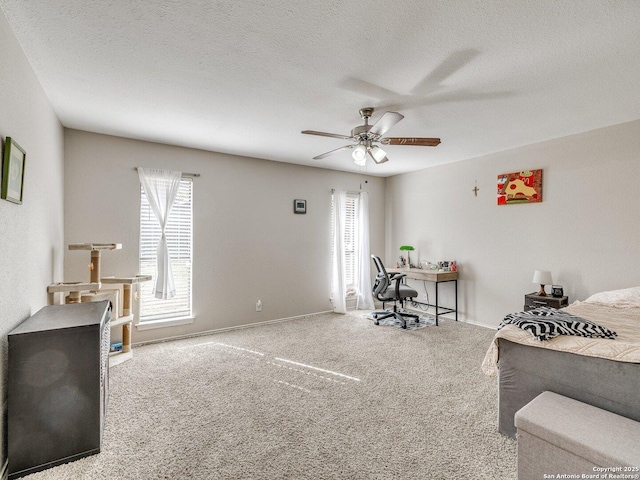 bedroom with ceiling fan, a textured ceiling, and carpet flooring