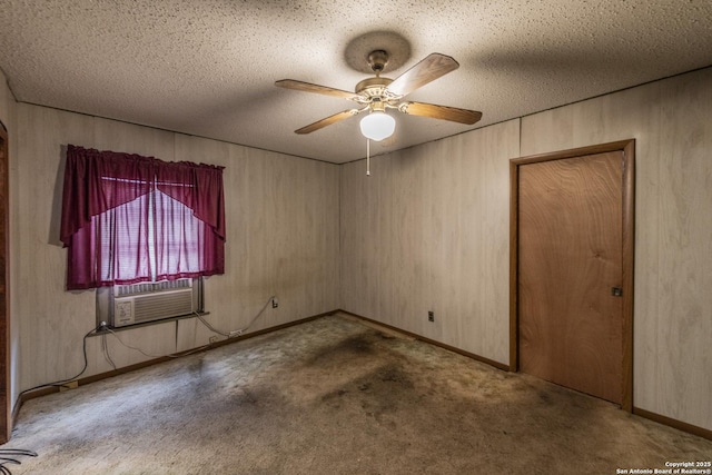 carpeted spare room featuring cooling unit, ceiling fan, and a textured ceiling