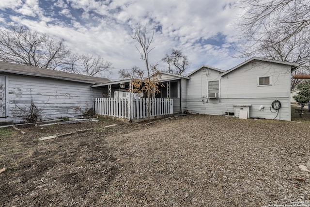 back of property featuring cooling unit