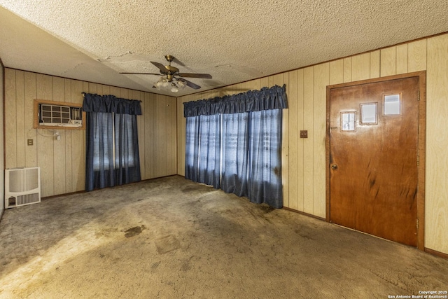 interior space featuring a healthy amount of sunlight, a textured ceiling, ceiling fan, and carpet