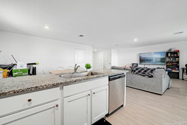 kitchen featuring sink, white cabinetry, dishwasher, light stone countertops, and light hardwood / wood-style floors