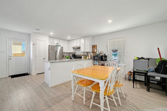 dining space featuring light hardwood / wood-style floors