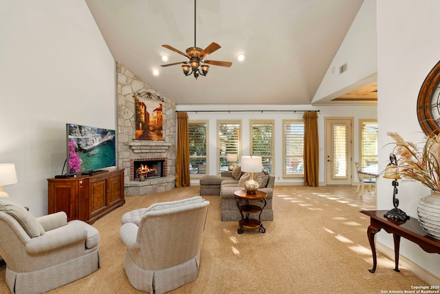 living room featuring ceiling fan, light colored carpet, a fireplace, and high vaulted ceiling