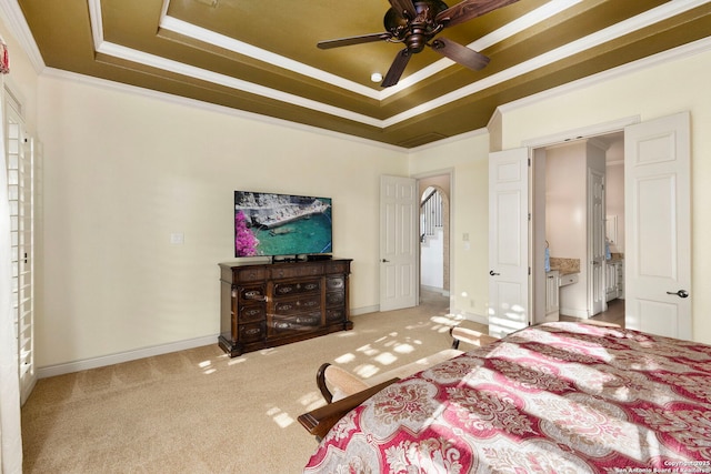 carpeted bedroom featuring a tray ceiling and ornamental molding