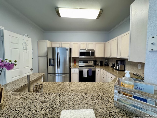 kitchen featuring tasteful backsplash, ornamental molding, stainless steel appliances, and white cabinets