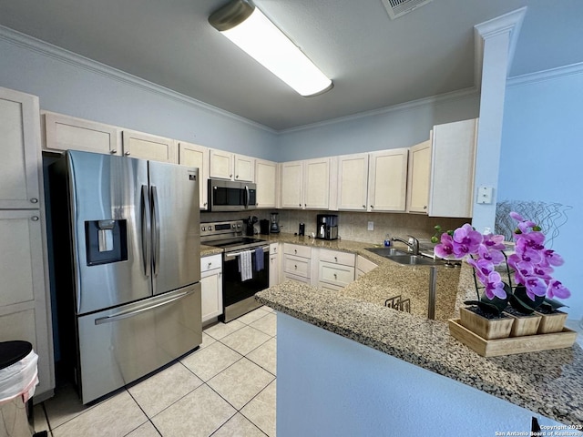 kitchen with crown molding, appliances with stainless steel finishes, sink, and kitchen peninsula