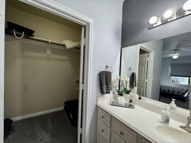 bathroom featuring ceiling fan and vanity