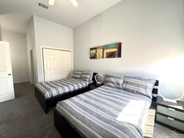 carpeted bedroom featuring ceiling fan, vaulted ceiling, and a closet