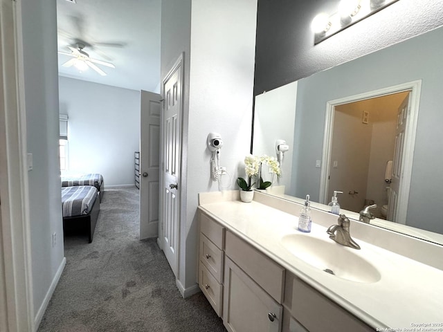 bathroom with ceiling fan and vanity