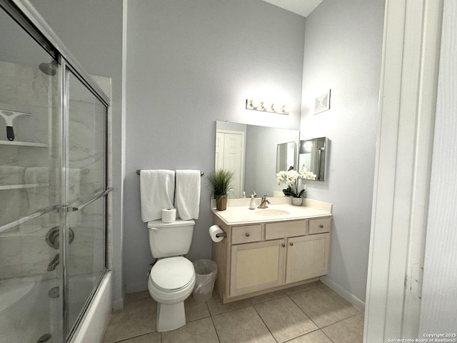 full bathroom featuring vanity, tile patterned flooring, shower / bath combination with glass door, and toilet