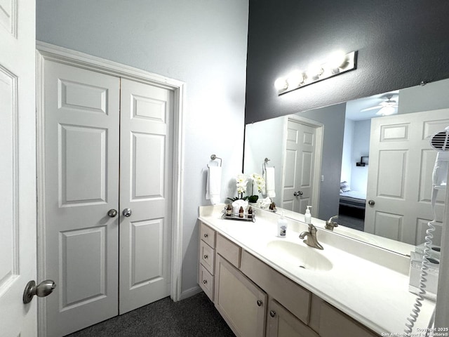 bathroom with ceiling fan and vanity