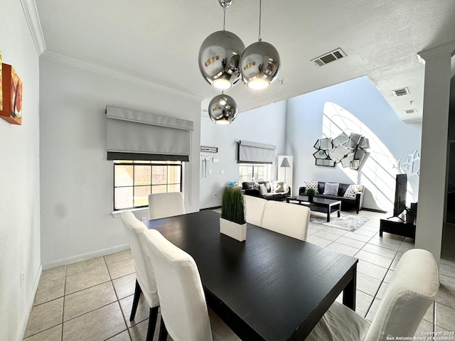 dining space with light tile patterned floors and crown molding