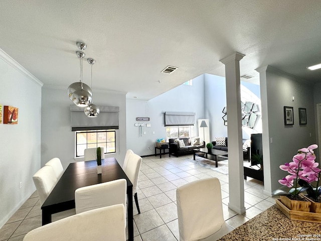 tiled dining area with crown molding, a wealth of natural light, a textured ceiling, and ornate columns