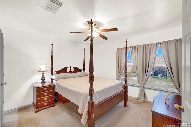 bedroom featuring light carpet and ceiling fan