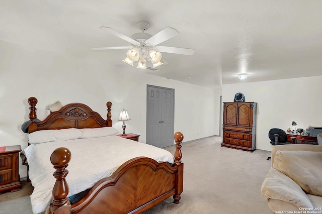 bedroom featuring light colored carpet, a closet, and ceiling fan