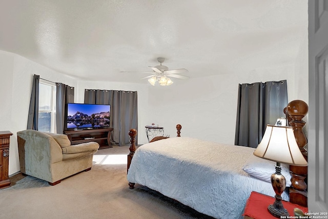 bedroom featuring light colored carpet and ceiling fan