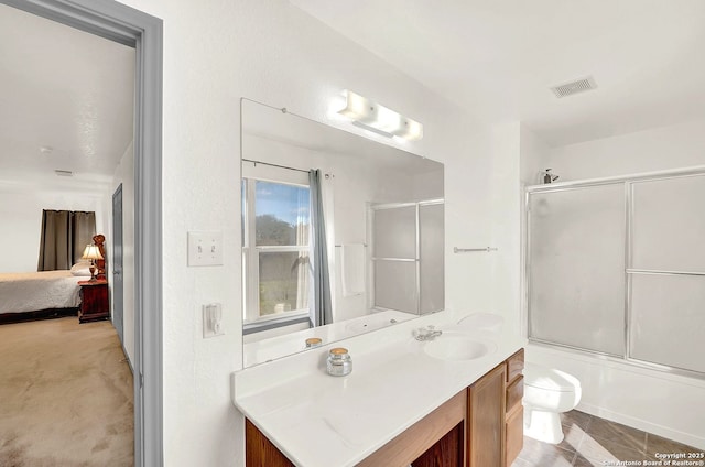 full bathroom featuring bath / shower combo with glass door, vanity, and toilet