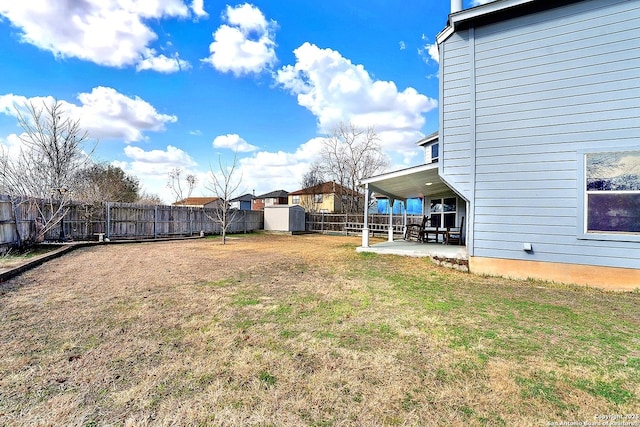 view of yard with a shed and a patio area