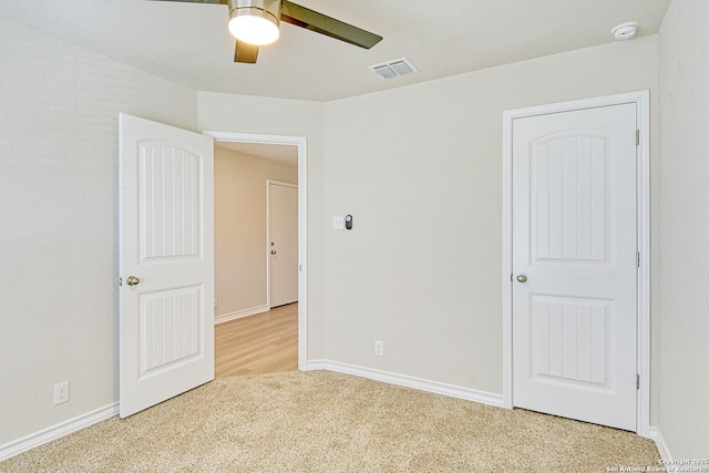 unfurnished bedroom with light carpet and ceiling fan