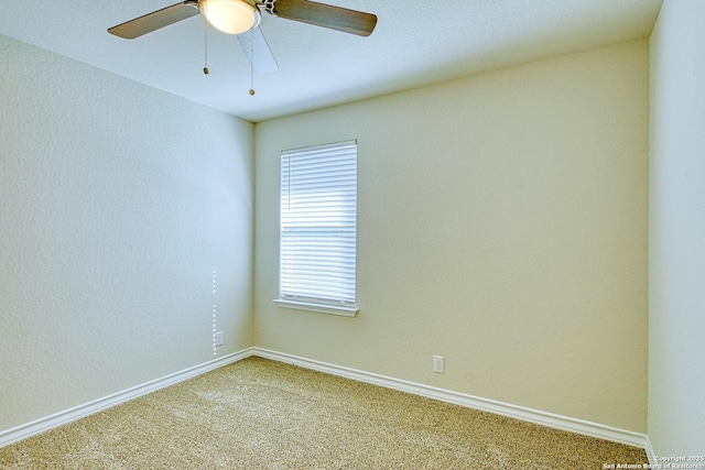 spare room featuring ceiling fan and carpet