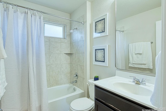 full bathroom with vanity, shower / bath combo, and toilet