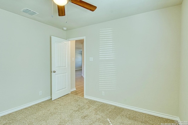 carpeted spare room featuring ceiling fan