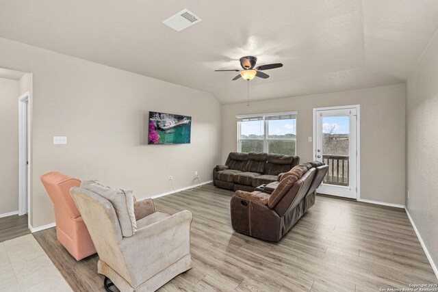 living room with wood-type flooring, ceiling fan, and vaulted ceiling