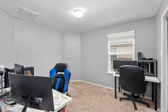 carpeted office with a textured ceiling