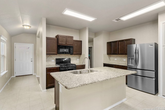 kitchen with sink, a center island with sink, dark brown cabinetry, and black appliances