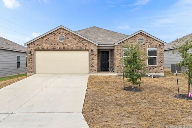 single story home with a garage and central AC unit