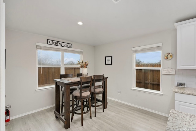 dining space with light hardwood / wood-style floors