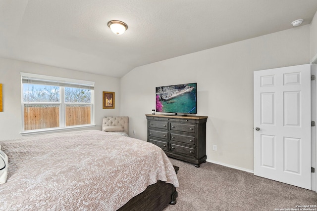 bedroom with lofted ceiling, light carpet, and a textured ceiling