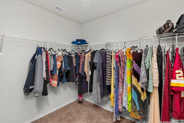 walk in closet featuring carpet