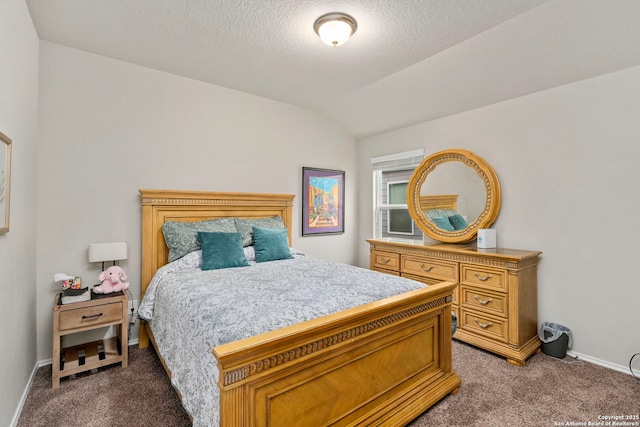 bedroom featuring vaulted ceiling, a textured ceiling, and carpet