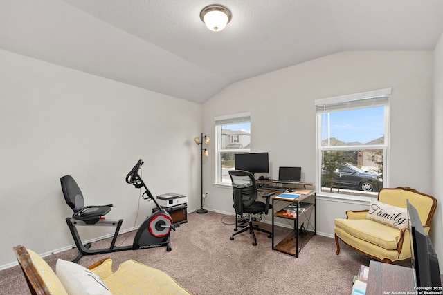 carpeted office featuring lofted ceiling and plenty of natural light