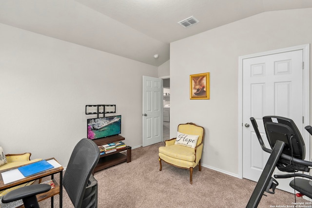 office space with lofted ceiling and light carpet