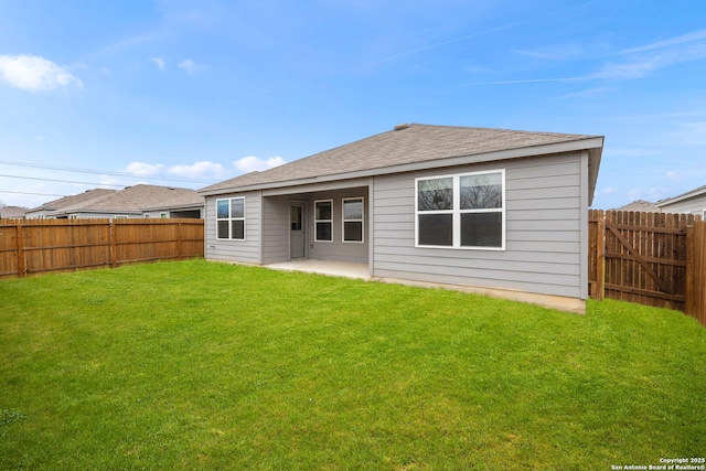 rear view of property with a patio area and a lawn