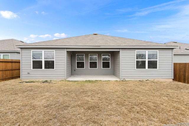 rear view of house with a patio and a lawn