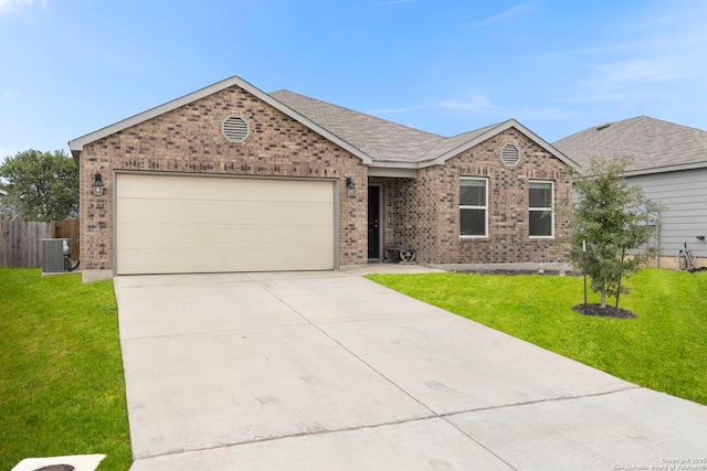 single story home with a garage, a front yard, and central air condition unit