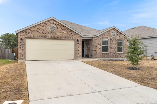 single story home featuring a garage and central AC unit