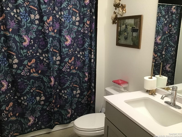 bathroom featuring vanity and toilet