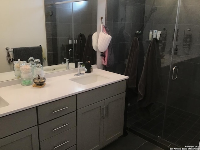 bathroom featuring vanity, tile patterned flooring, and a shower with door