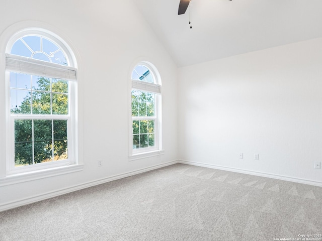 unfurnished room with high vaulted ceiling, carpet floors, and ceiling fan