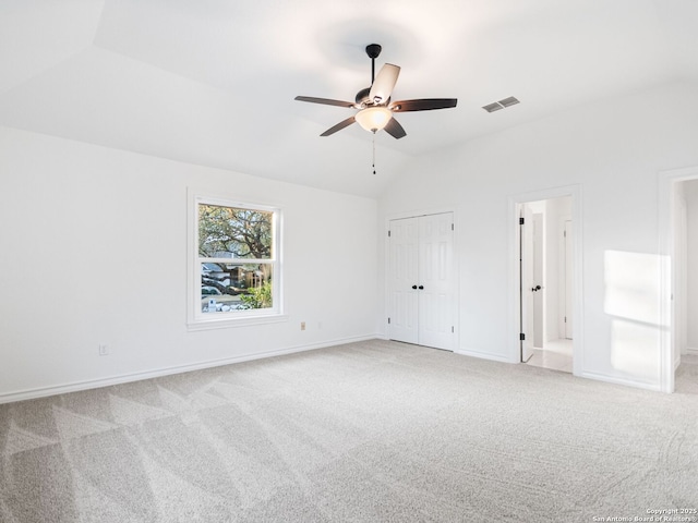 unfurnished room featuring lofted ceiling, light carpet, and ceiling fan