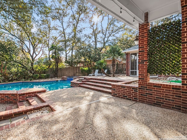 view of pool featuring an in ground hot tub and a patio