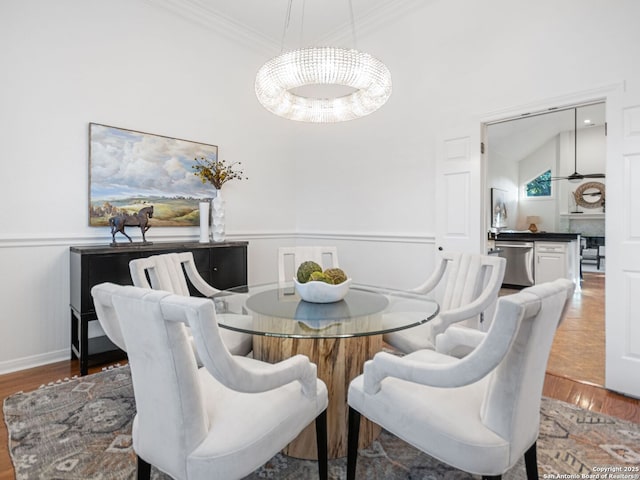 dining space with crown molding and wood-type flooring