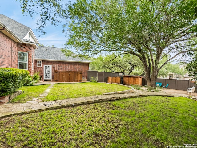 view of yard with a patio area and a hot tub